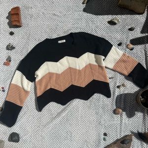 Black, white, and pink knitted zigzag sweater